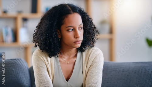 Woman Feeling isolated and dejected, they sit in their apartment, contemplating the end of their relationship. Depression, heartbreak and sad with face of woman on sofa in living room.