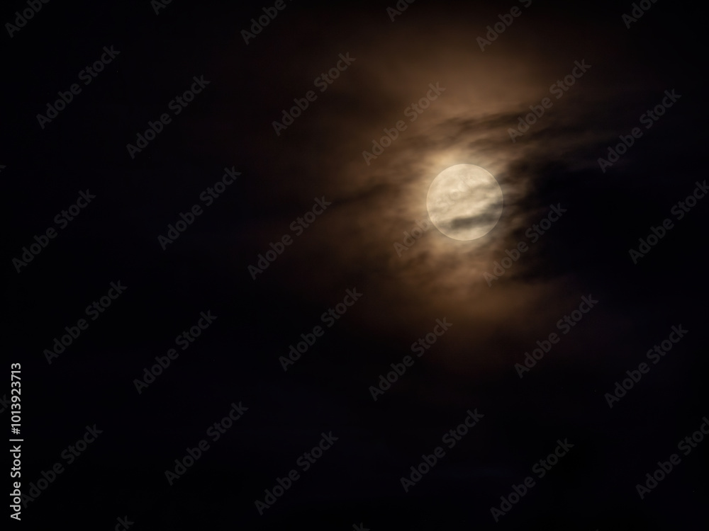 full moon under heavy clouds full moon under heavy clouds