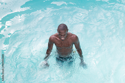 Man enjoying a swim in clear blue water