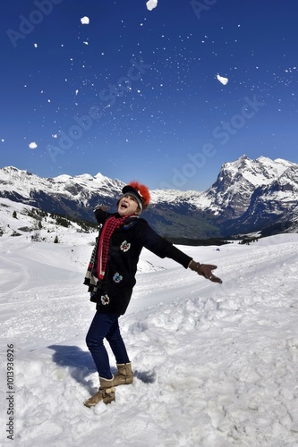 Asian woman enjoying the snow in the mountains, Kleine Scheidegg, Swiss Alps, Bernese upper land, Canton of Bern, Switzerland, Europe