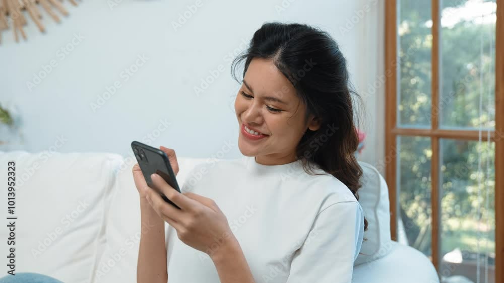 Young woman using smartphone browsing for online shopping E commerce by online payment gateway at vivancy home. Modern and convenience online purchasing make secure and convenient purchases. Young woman using smartphone browsing for online shopping E commerce by online payment gateway at vivancy home. Modern and convenience online purchasing make secure and convenient purchases.