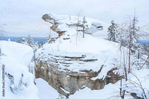 Stone city in the woods moss-grown nature in the winter. Usva, Ural.