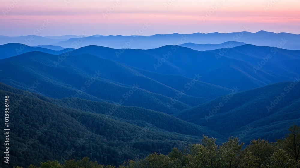 Blue Ridge Mountains at sunset, with a soft pink sky and layers of hills. Blue Ridge Mountains at sunset, with a soft pink sky and layers of hills.