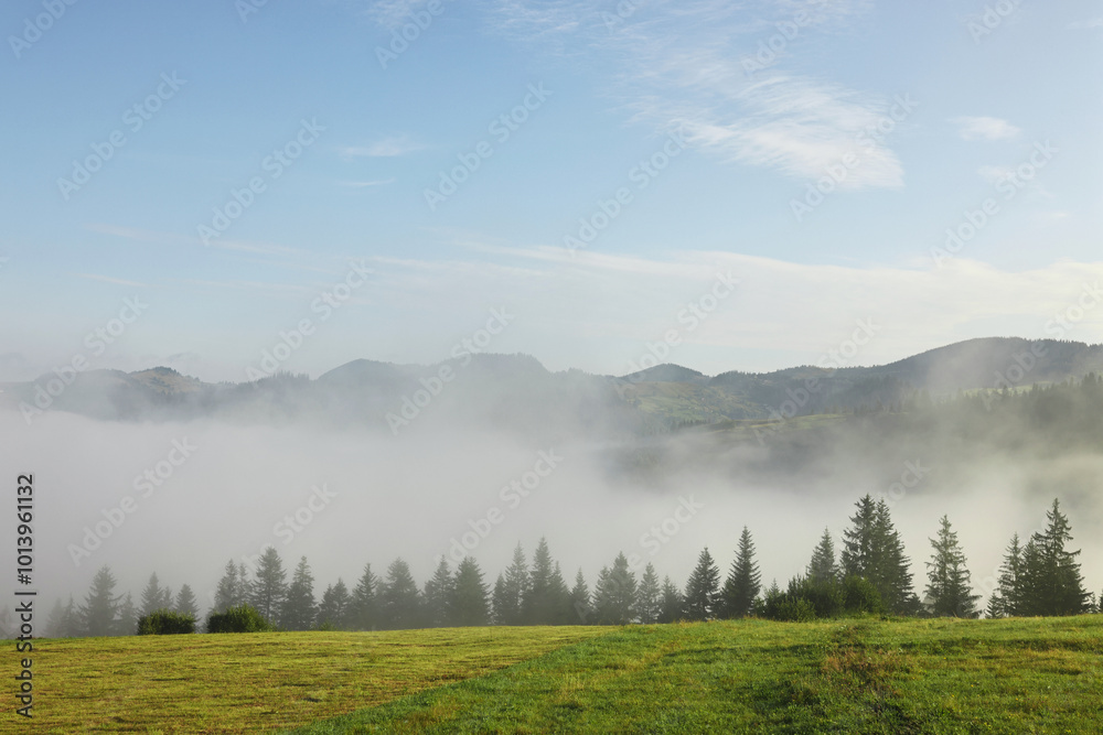 Picturesque view of mountains covered with fog Picturesque view of mountains covered with fog