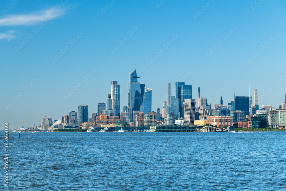Panoramic view of the Manhattan skyline from Hoboken, New Jersey, set against a clear blue sky. Panoramic view of the Manhattan skyline from Hoboken, New Jersey, set against a clear blue sky.