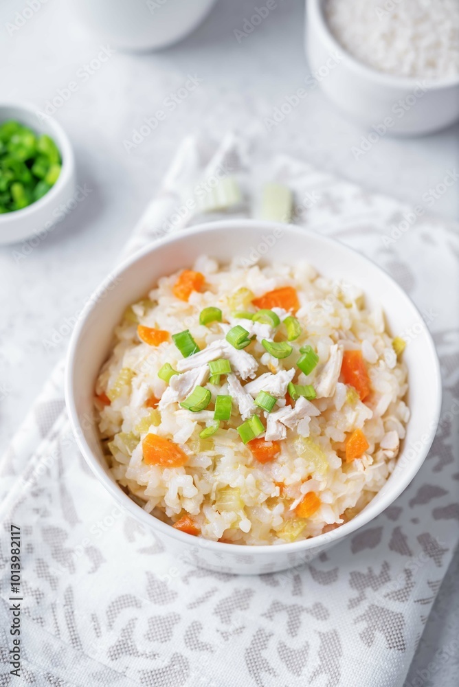 Asian rice chicken soup with carrots and celery in a bowl Asian rice chicken soup with carrots and celery in a bowl