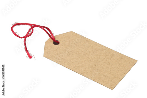 Brown kraft paper tag with red string isolated on black background. 