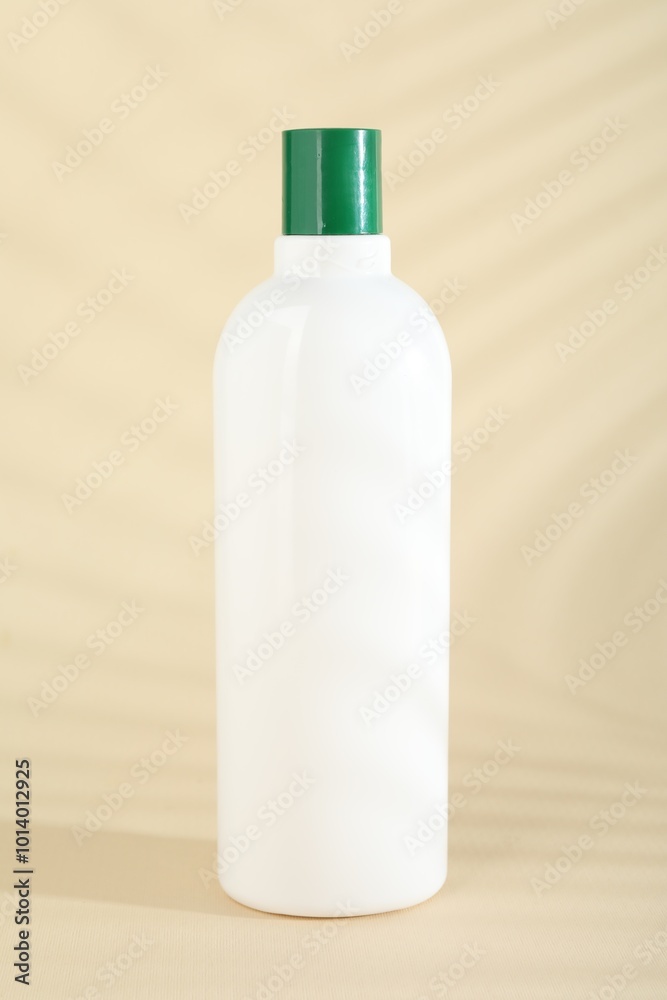 One shampoo in bottle on beige background One shampoo in bottle on beige background