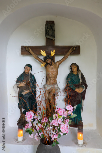 A group of "crucifixion" figures in the interior of an 18th-century roadside shrine in Pszczyna, Poland.