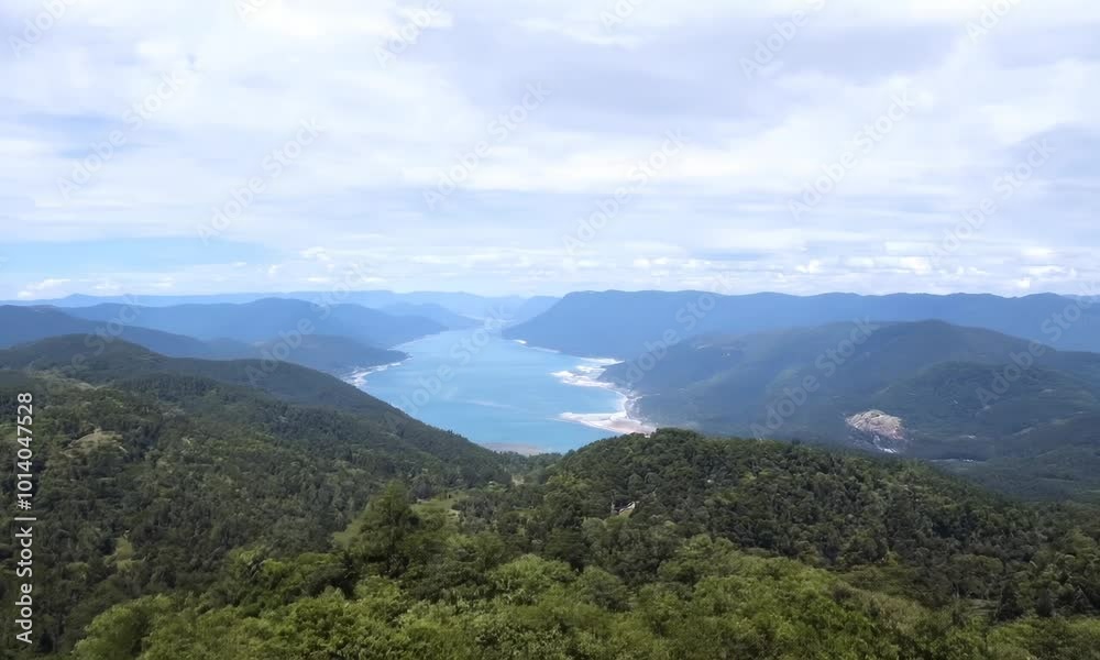 Beautiful mountain range with a lake in the distance. The sky is cloudy and the mountains are covered in trees. hyperrealistic Video Beautiful mountain range with a lake in the distance. The sky is cloudy and the mountains are covered in trees. hyperrealistic Video
