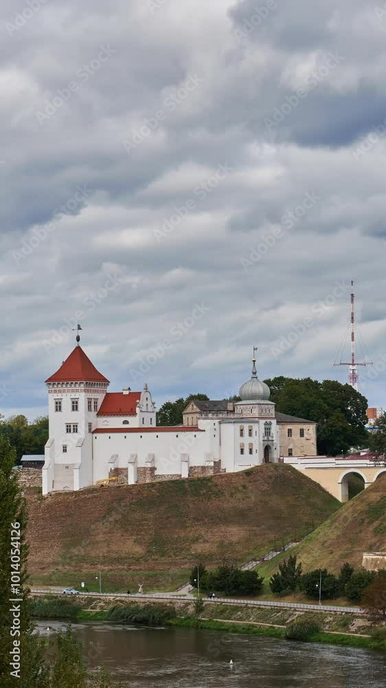 A timelapse of clouds over the old castle and the river. An ancient historical message on the riverbank. The old castle in Grodno. A timelapse of clouds over the old castle and the river. An ancient historical message on the riverbank. The old castle in Grodno.