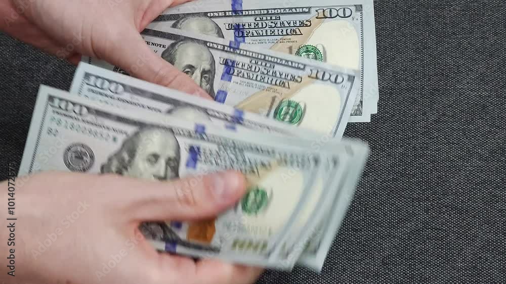Person counting dollar banknotes in hands. Close-up view of cash counting process. Financial management and money concept.