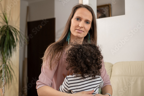 Mother embracing child, tender moment at home, family connection, loving bond in cozy living room, warmth and affection, domestic life concept