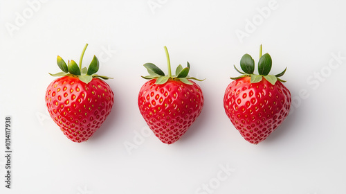 Three fresh strawberries with green leaves are neatly arranged in row on white background, showcasing their vibrant red color and juicy texture.