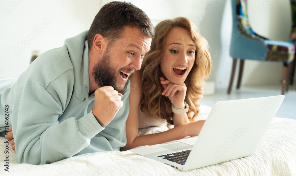 happy couple using laptop at home happy couple using laptop at home