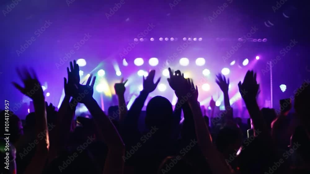 Crowd cheering and raising arms during live music event Crowd cheering and raising arms during live music event