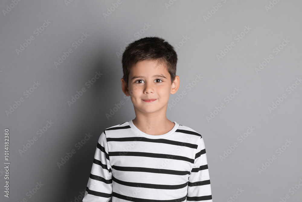 Portrait of cute little boy on grey background Portrait of cute little boy on grey background