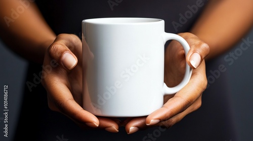 Hands gently cradling a pristine white ceramic mug against a dark background, symbolizing comfort and warmth in a minimalist, elegant composition.