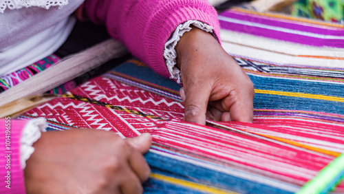 Close up Andean woman weaving alpaca textiles tecnique photo