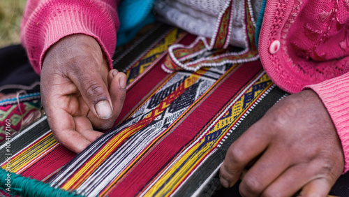 Up close Andean woman weaving alpaca textiles