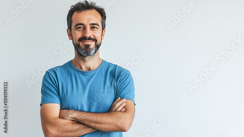 a man with a beard stands with his arms crossed blue november photo