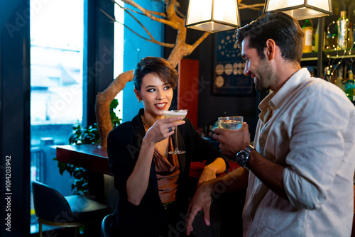 Canvas Print Caucasian man and woman dating and hanging out drinking alcoholic cocktail on holiday event at luxury restaurant bar