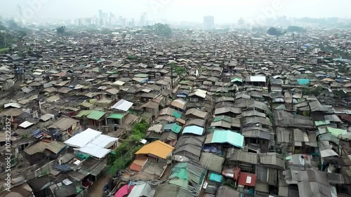 Densely packed shantytown spreads out below city skyline