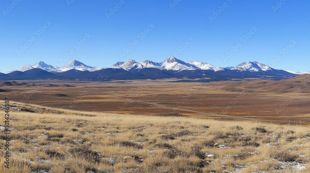 A scenic road stretching across a vast plain, leading toward distant mountains with a clear sky above. A scenic road stretching across a vast plain, leading toward distant mountains with a clear sky above.