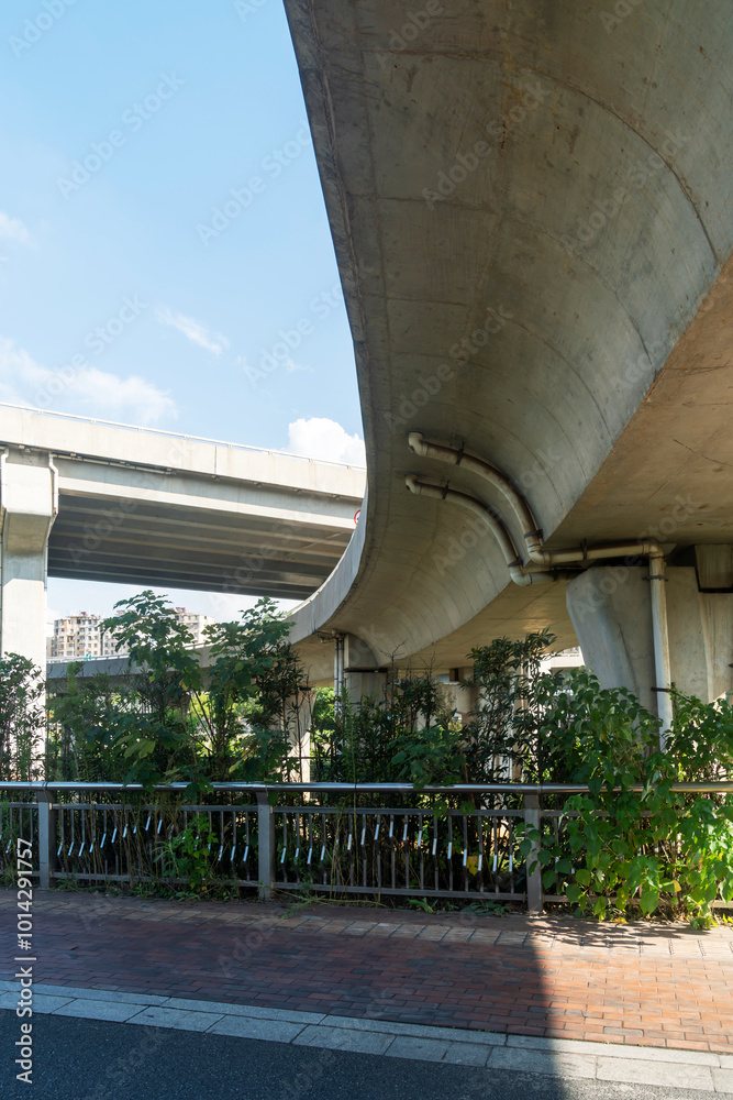 Concrete structure and asphalt road space under the overpass in the city Concrete structure and asphalt road space under the overpass in the city