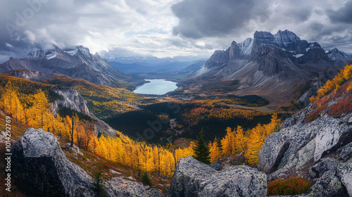 Stunning fall landscape with golden larch trees and rugged mountains in a serene valley at twilight