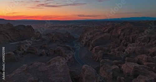 Asphalt road and spectacular yardan landform natural scenery at night. The famous Dahaidao uninhabited area natural landscape in Xinjiang, China. photo