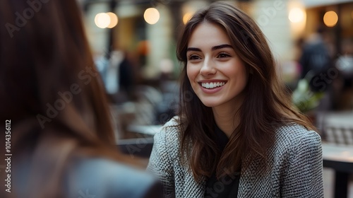 Smiling Woman with Brown Hair and White Teeth in a Cafe photo