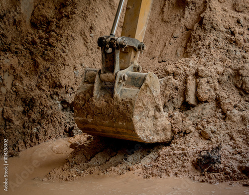 A significant pile of ground is being excavated by a bulldozer