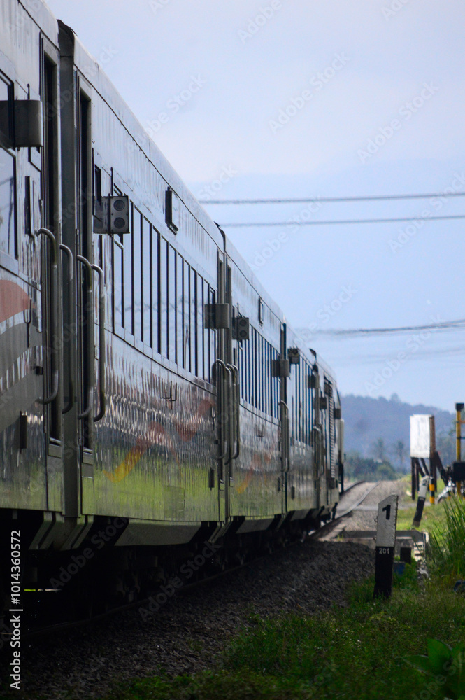 Naklejka premium The train passes through the countryside with beautiful natural views.