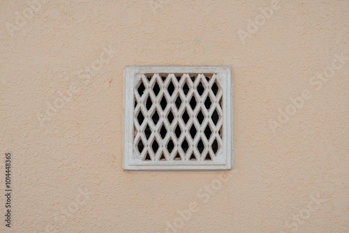 retro ventilation grille on wall, plaster background