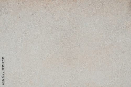 Textured Plaster Wall Background. A close-up of a textured plaster wall with an abstract rough surface. The neutral light beige color and irregular patterns create a natural and artistic backdrop. 