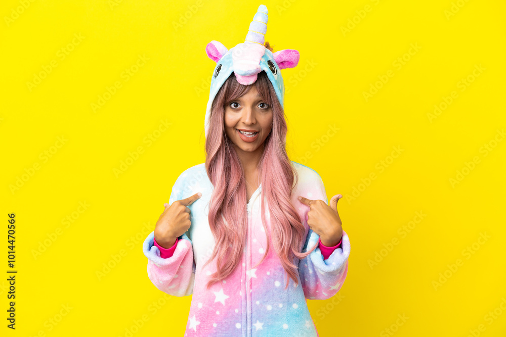 Young mixed race woman wearing a unicorn pajama isolated on white background with surprise facial expression Young mixed race woman wearing a unicorn pajama isolated on white background with surprise facial expression