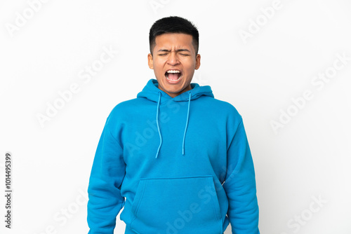 Young Ecuadorian man isolated on white background shouting to the front with mouth wide open