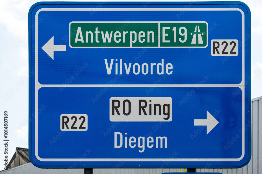 Machelen, Flanders, Belgium - Road direction signs to the E19 highway and the R0 and R22 ring roads Machelen, Flanders, Belgium - Road direction signs to the E19 highway and the R0 and R22 ring roads