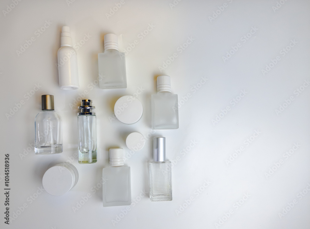 Close-up of glass perfume bottle and round jar on isolated white background Close-up of glass perfume bottle and round jar on isolated white background