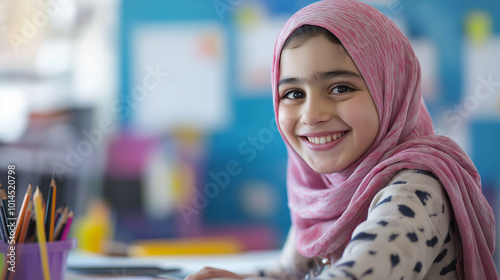 Close-Up of a Middle Eastern Girl Smiling While Drawing at Her Desk, Capturing Her Creative and Joyful Expression