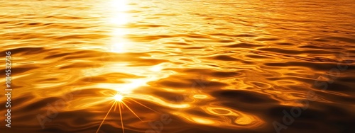 Golden sunset reflecting on the water surface, creating ripples and highlights