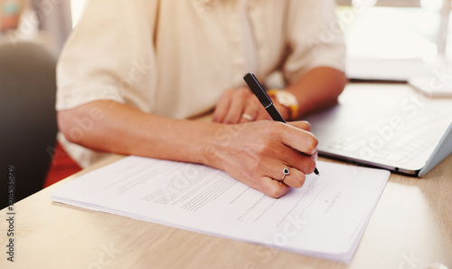 Closeup, laptop and businesswoman with paperwork for signature, agreement and compliance for loan. Office, female person and hands with legal document for contract, policy information and title deed