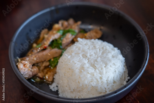 Rice with Kaprao beef served on plate. It is Thai style stir-fried holy basil with meat. photo