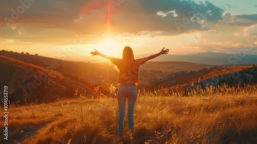 Embracing Serenity: Happy Woman Standing with Her Back to a Breathtaking Sunset in Nature