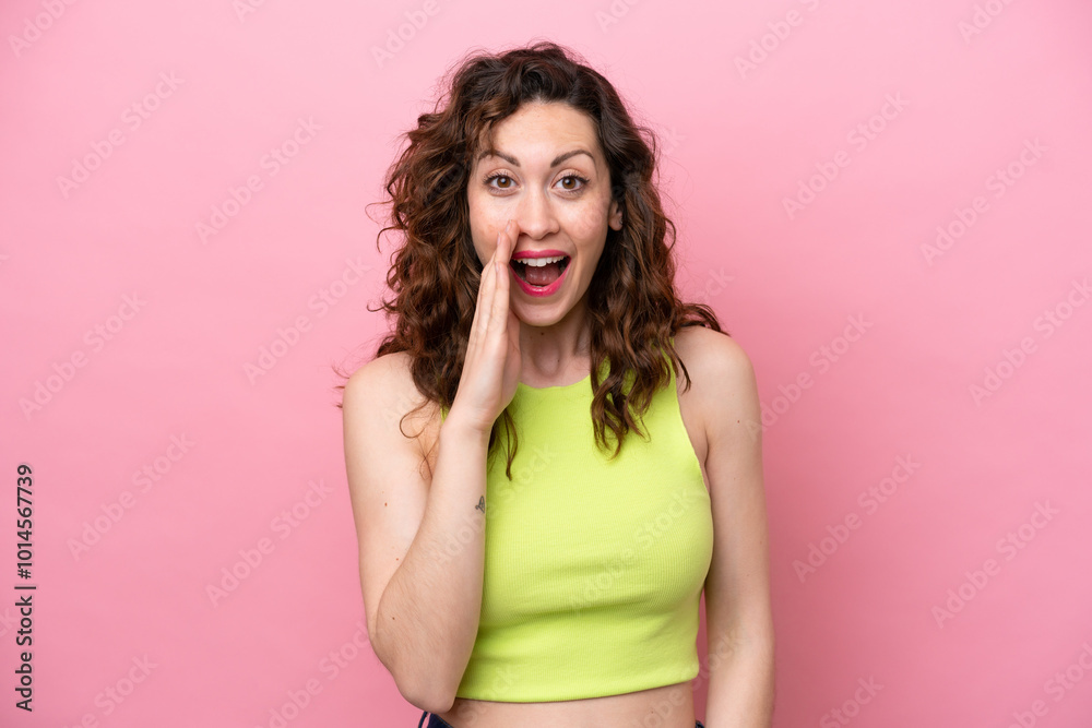 Young caucasian woman isolated on pink background with surprise and shocked facial expression