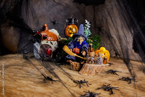 halloween card with sybil in a pointed hat with a jack-o-lantern and spiders sitting on a stump and conjuring over bottles in a gloomy forest in a web and preparing for All Saints' Day, artistic trick photo