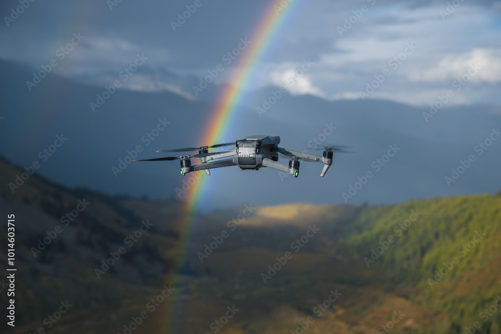 Fototapeta premium Drone taking photo of rainbow with a drone on high altitude grassland mountain top