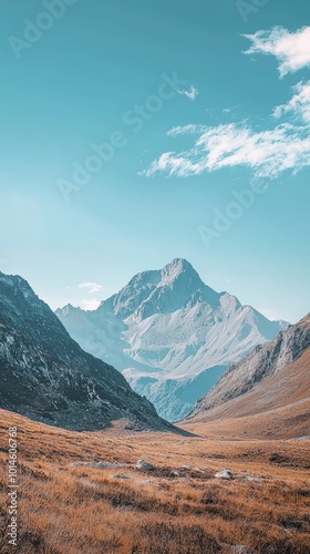 Breathtaking mountain landscape under a clear blue sky, showcasing valley beauty and serene natural scenery.