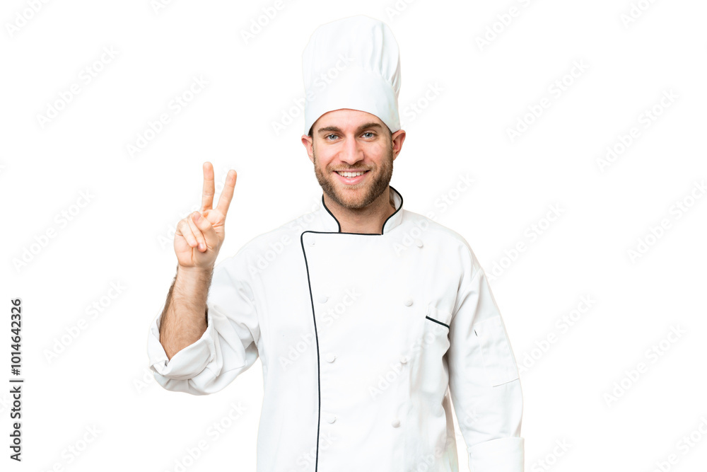 Young blonde man Chef over isolated chroma key background smiling and showing victory sign Young blonde man Chef over isolated chroma key background smiling and showing victory sign
